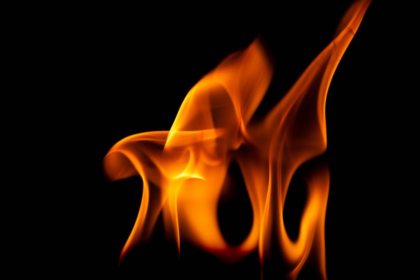 Hot flames on a black background. Beautiful flame of fire in the dark. Abstract of burning flames and smoke. photo