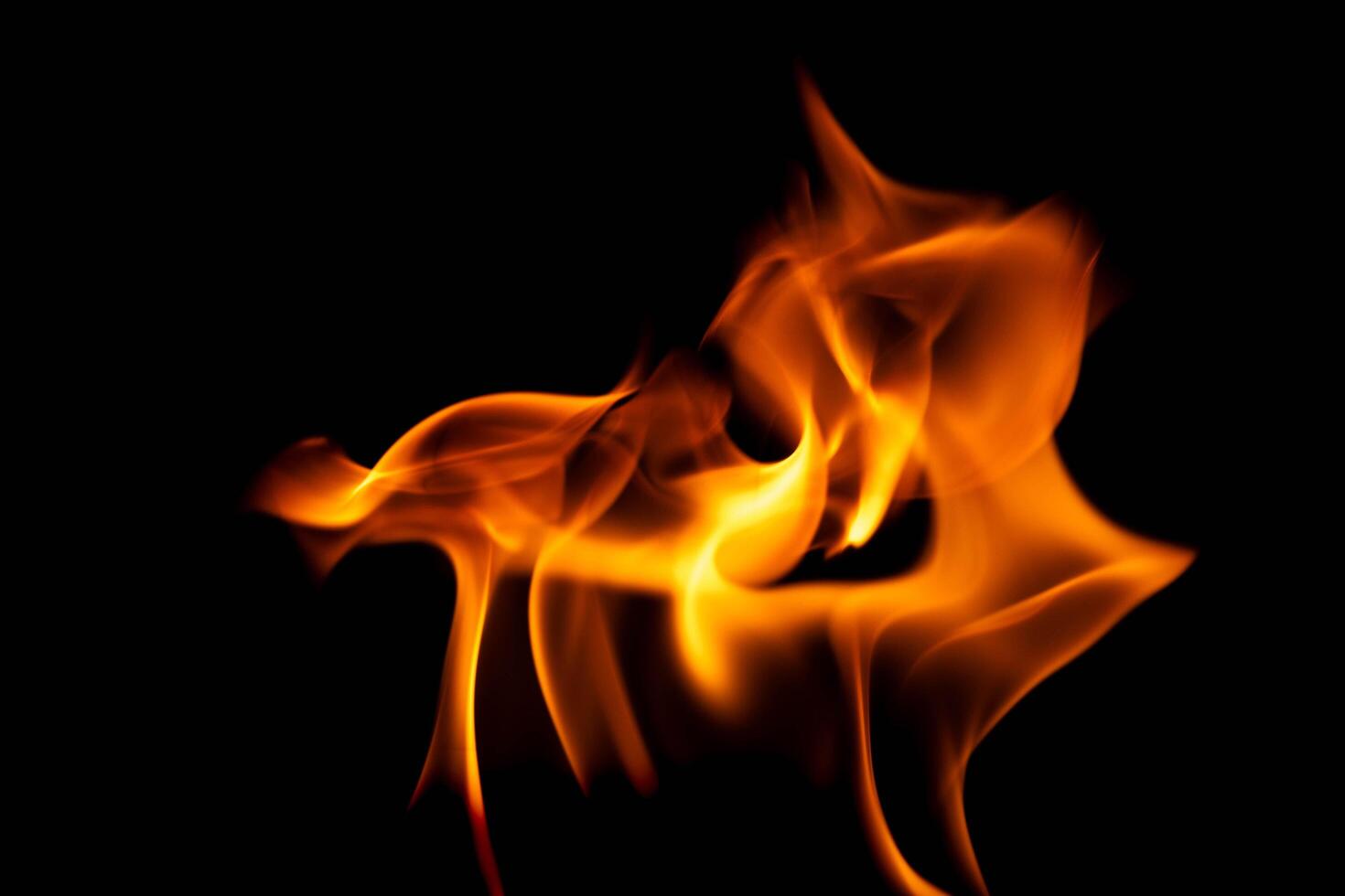 Hot flames on a black background. Beautiful flame of fire in the dark. Abstract of burning flames and smoke. photo