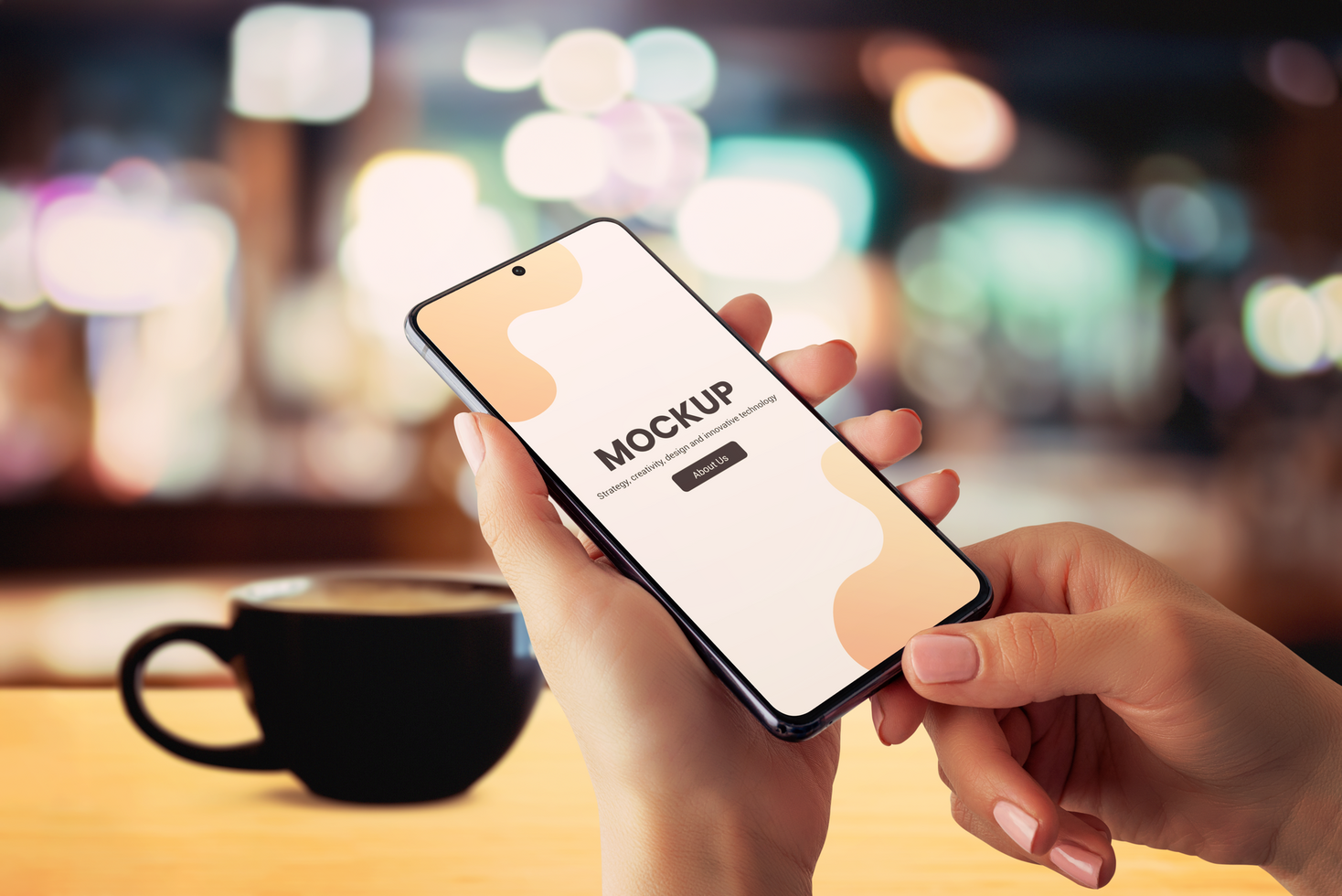 Smartphone mockup in hands with coffee mug on table psd