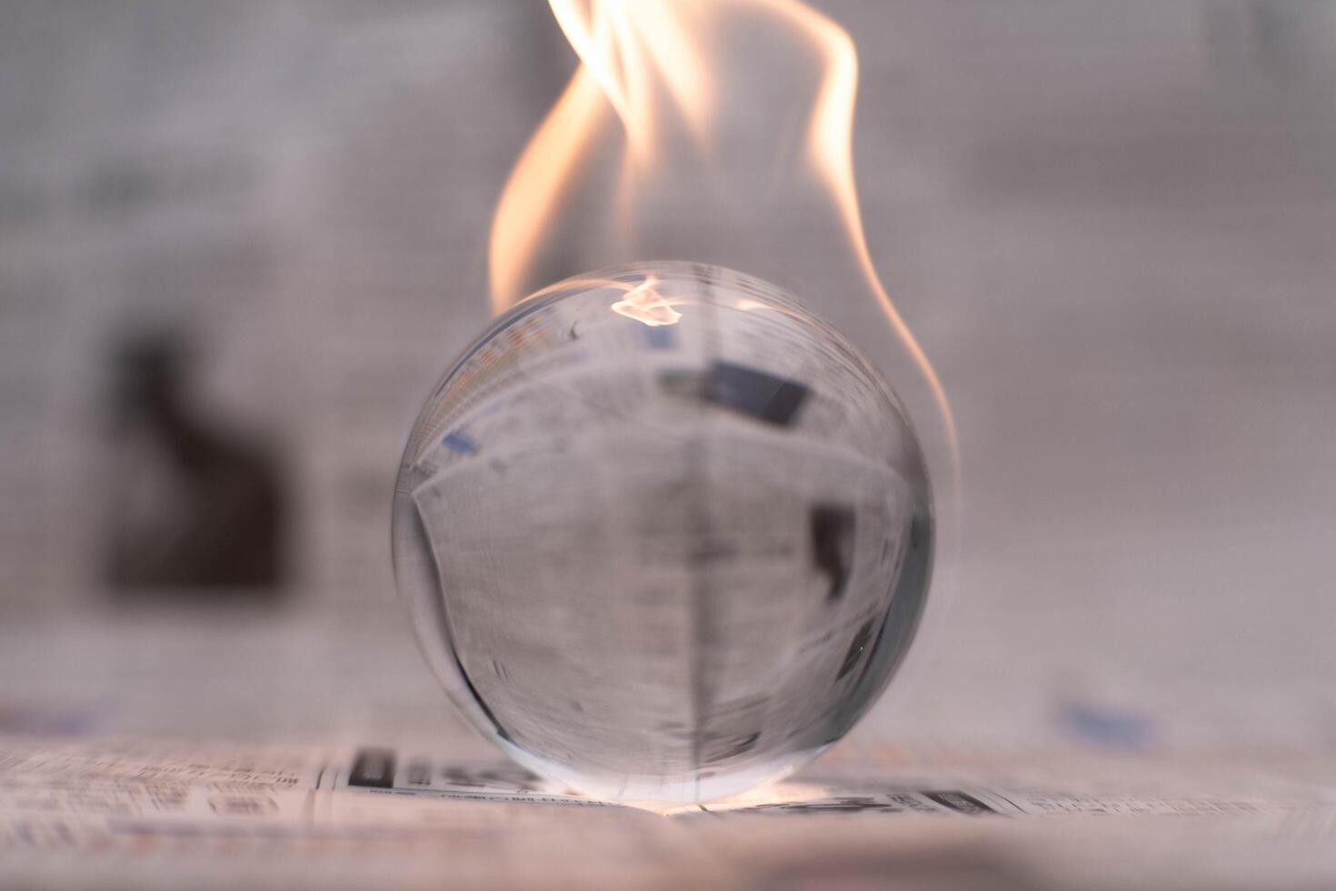 Glass globe on fire. Planet Earth Burning. Global Warming and Climate Change Concept. photo