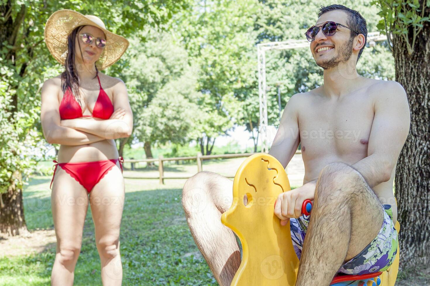 Young adult plays on a spring toy duck photo