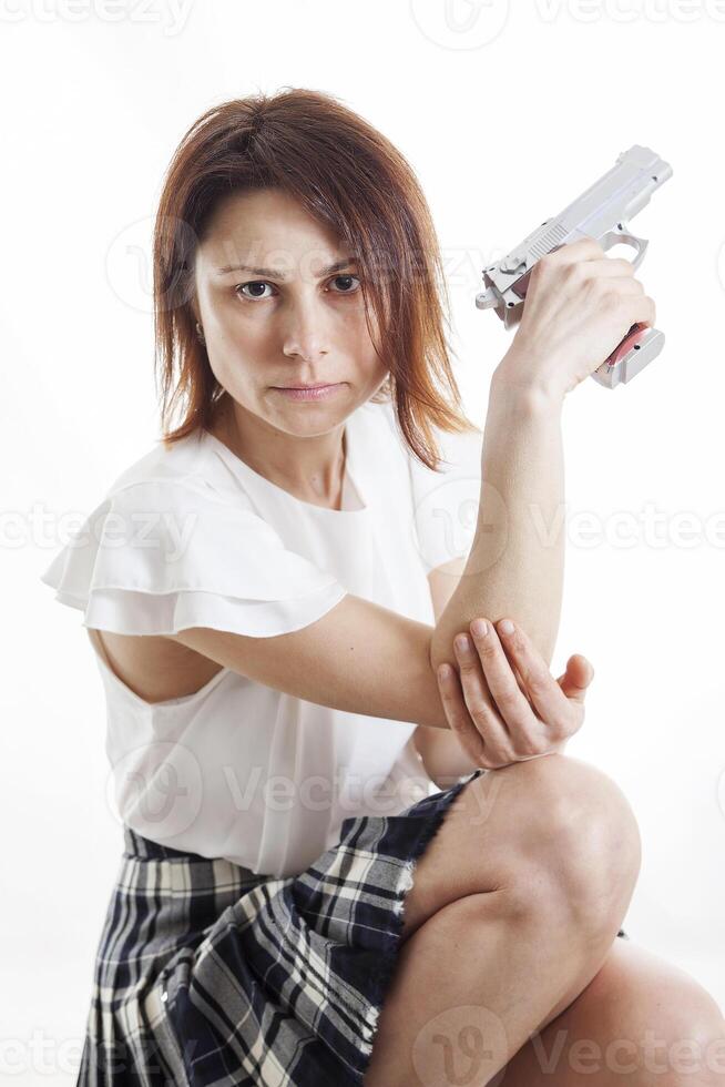 sexy woman posing with gun on white background photo