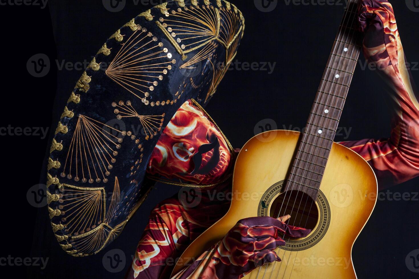 sensual woman dressed in a skeleton costume playing guitar photo