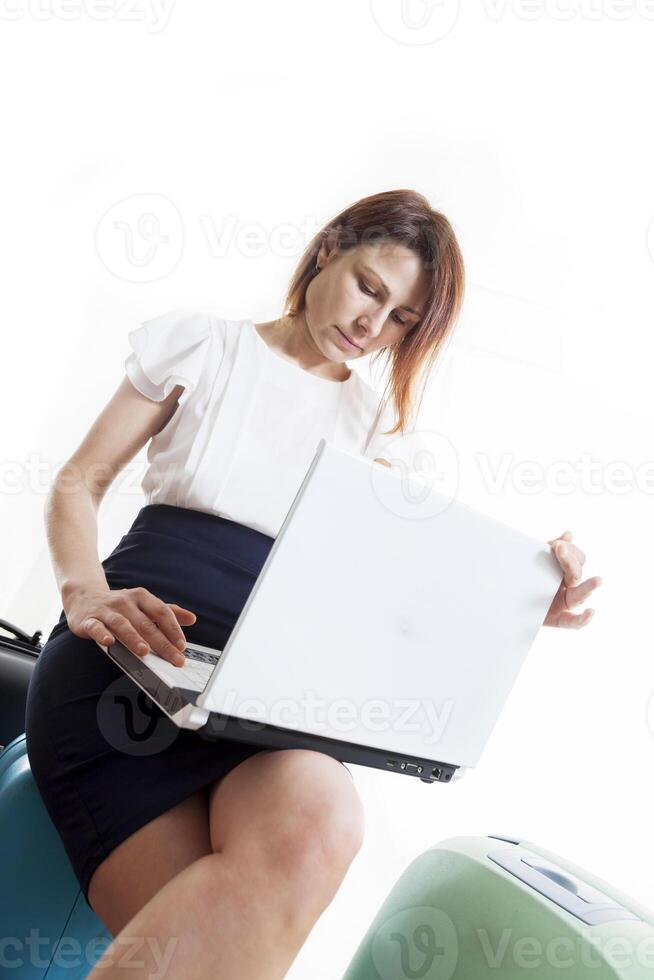 business woman with her suitcases ready to go photo