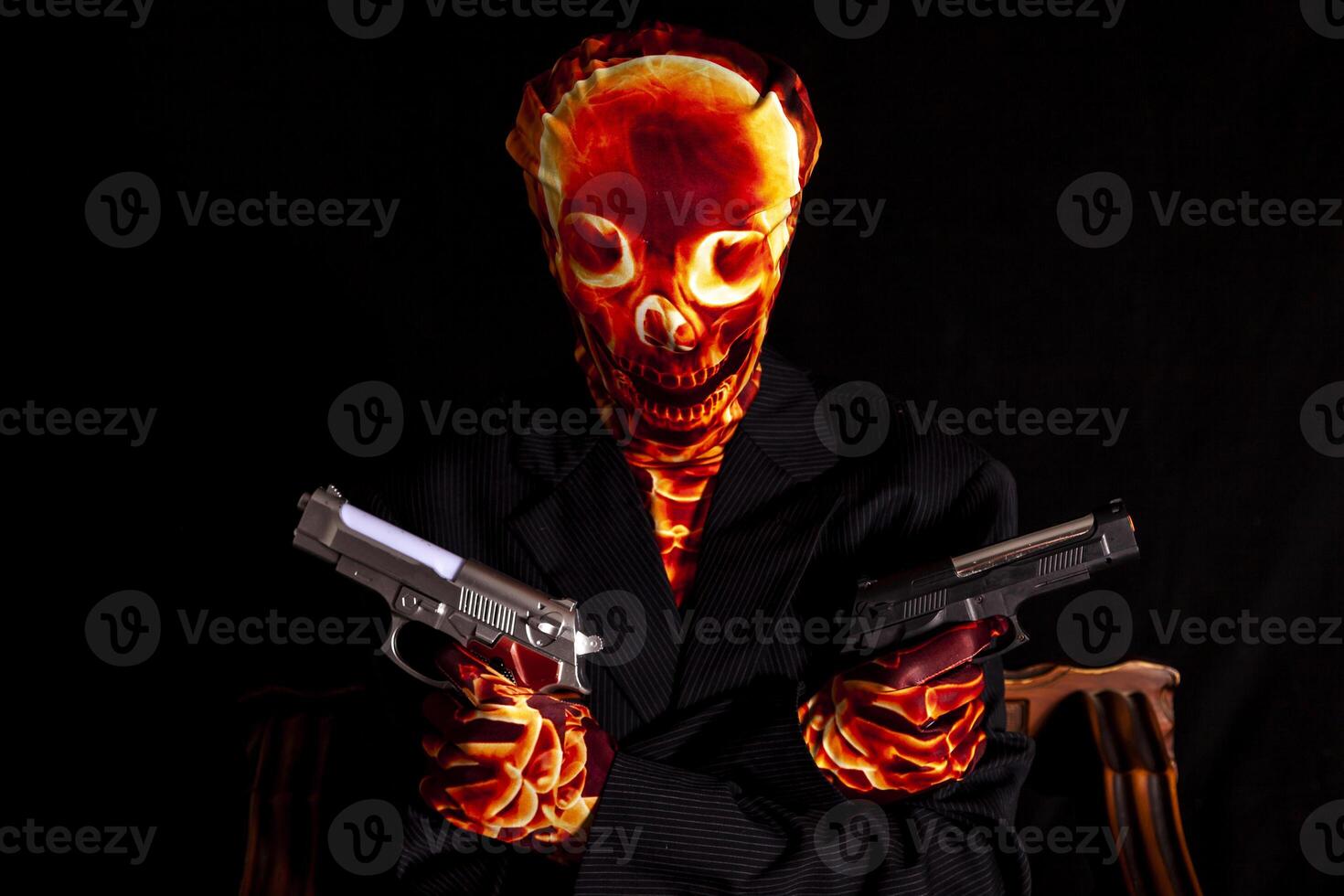 sensual woman dressed in a skeleton costume holding two guns photo