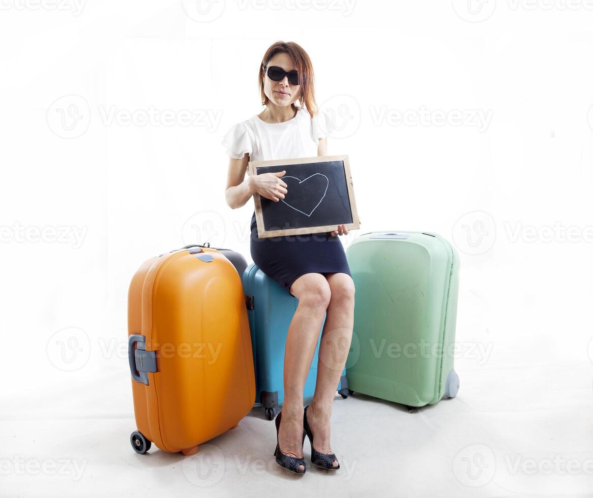 businesswoman with her suitcases waiting for love photo