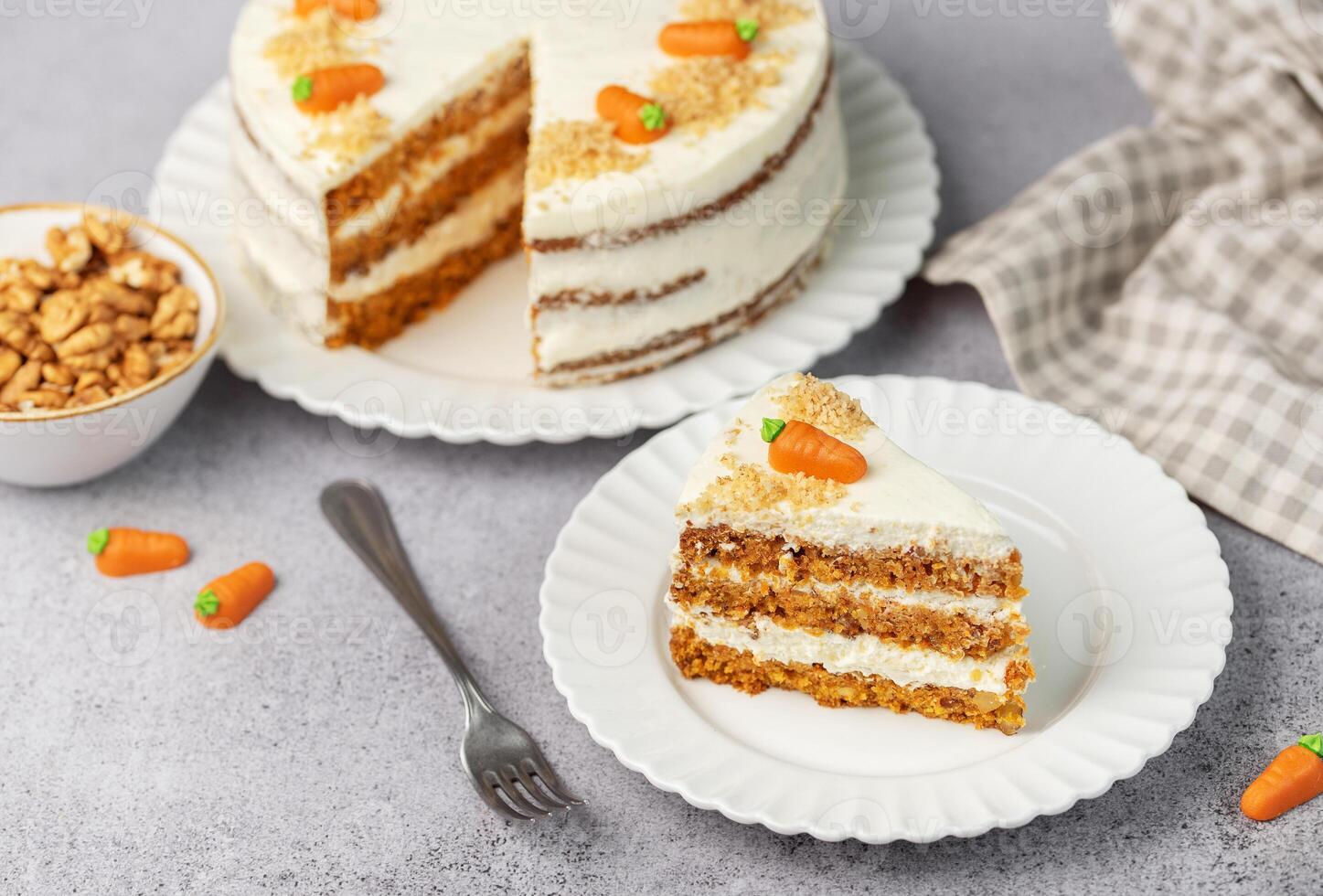 Homemade carrot cake made with walnuts, iced with cream cheese. Sweet dessert. photo