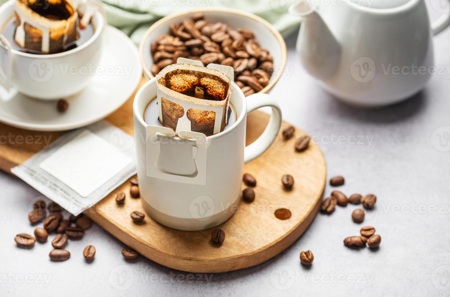 Drip coffee bag with ground coffee in  cup photo