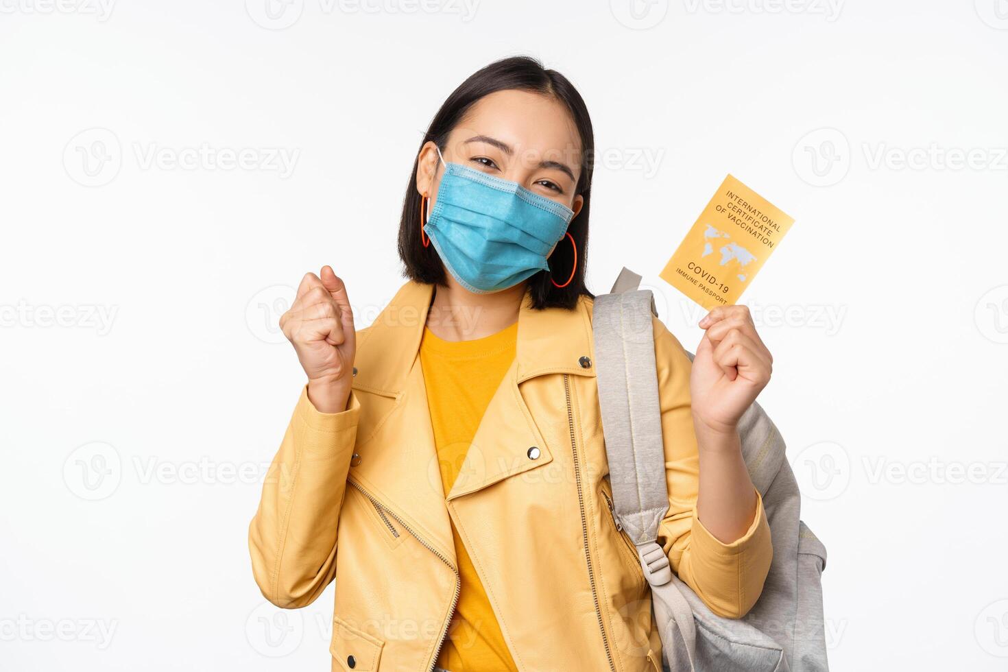 Hey you got point. Cheerful cute asian lively girl dark short haircut pointing camera finger-pistol smiling broadly, encourage friend make move, congratulate coworker good job, stand blue background photo