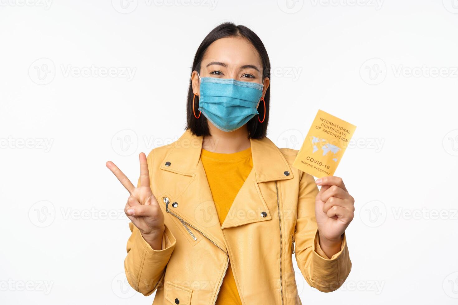 Hey you got point. Cheerful cute asian lively girl dark short haircut pointing camera finger-pistol smiling broadly, encourage friend make move, congratulate coworker good job, stand blue background photo