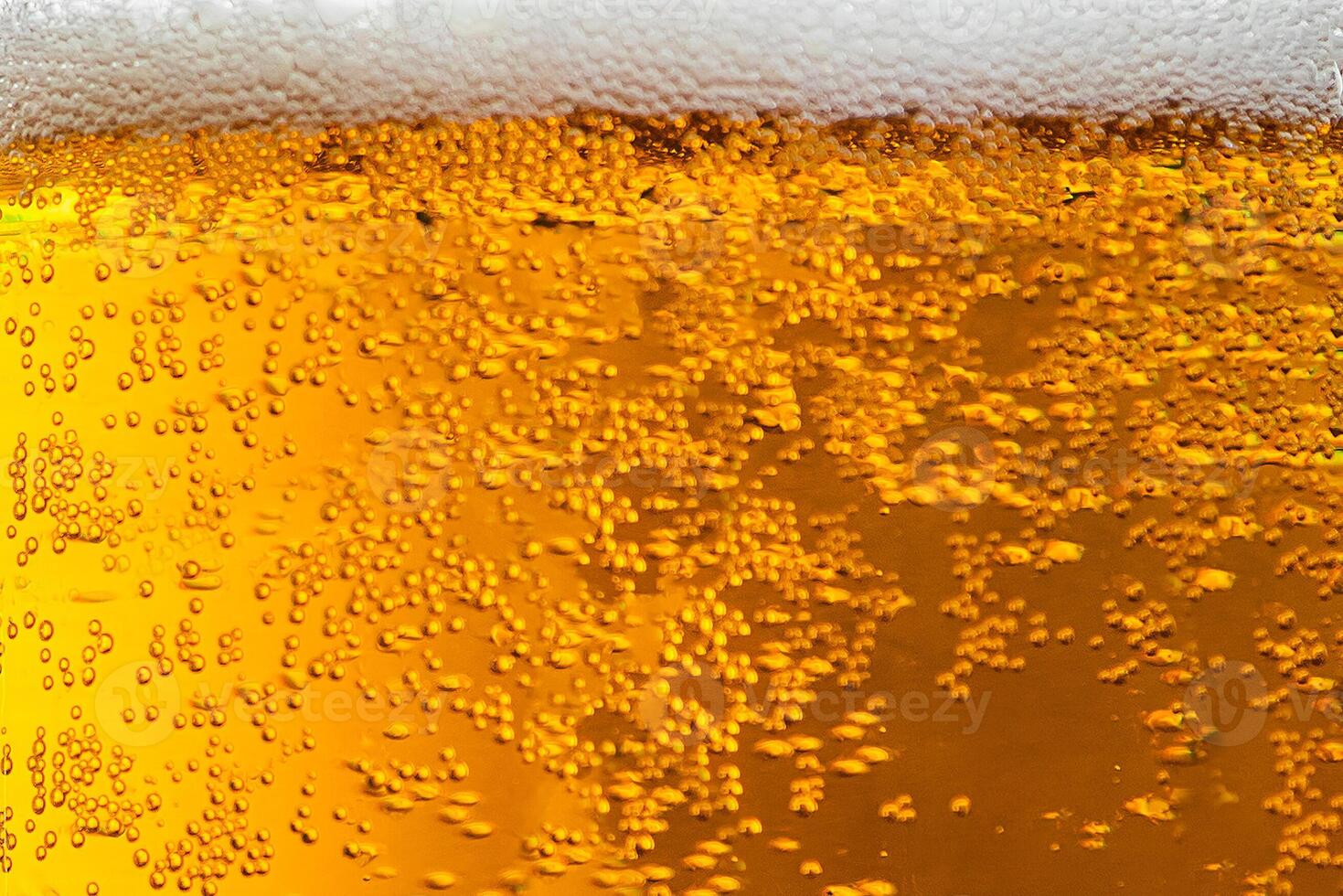 Light beer with foam in a glass. Bubbles close up. photo