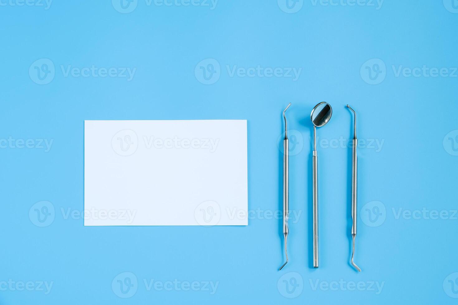 Happy Dentist Day. Paper cut mockup of tooth and dental tool on blue background. Dental care concept. photo