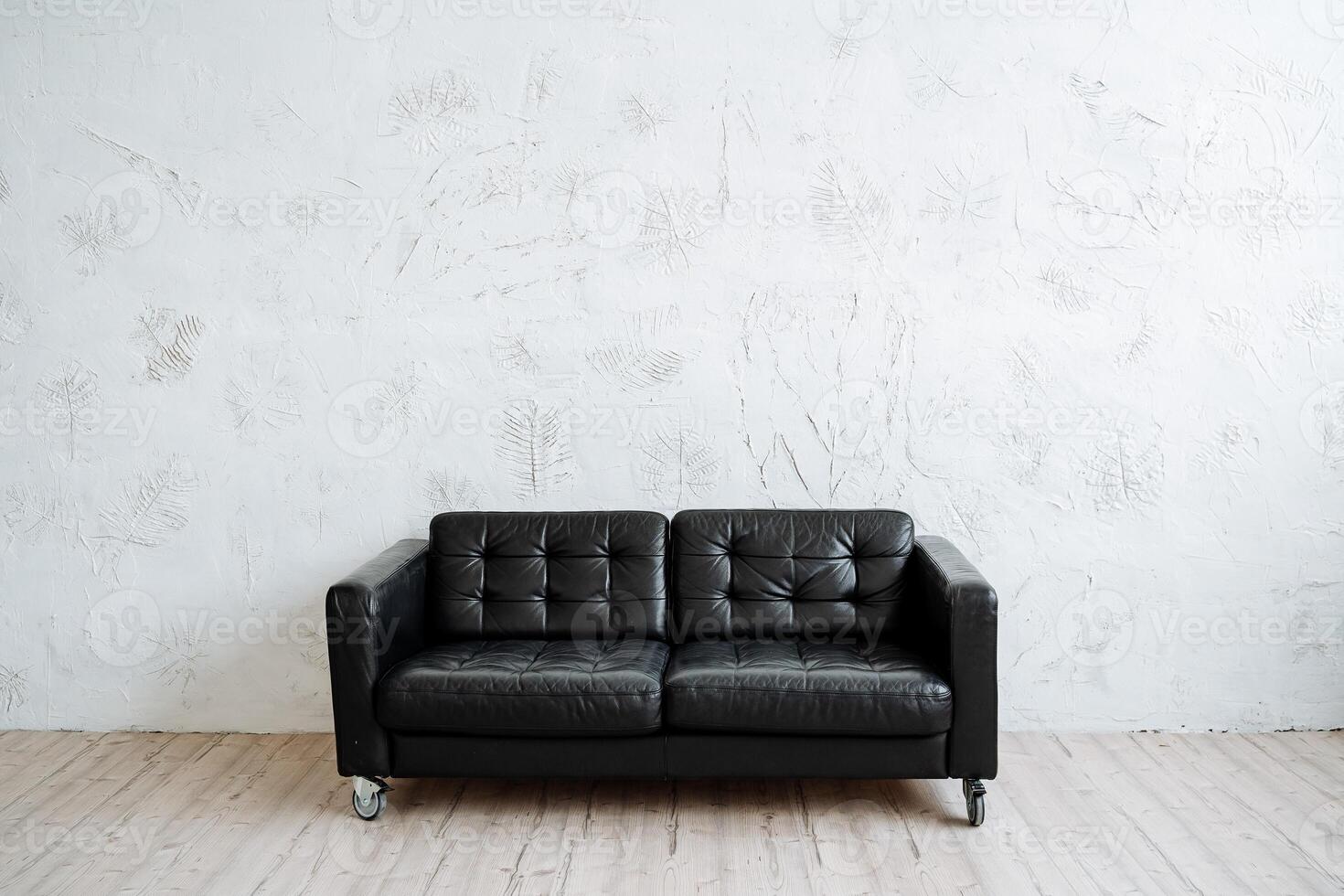 Perfect black leather sofa in a minimalist style. Modern furniture, convenience and comfort photo