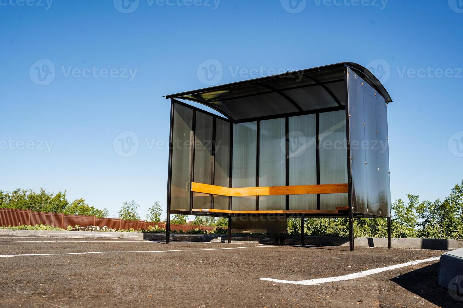 Polycarbonate at the stop for transport. Bus stop made of transparent plastic. Gazebo made of profile metal pipe and polycarbonate. photo