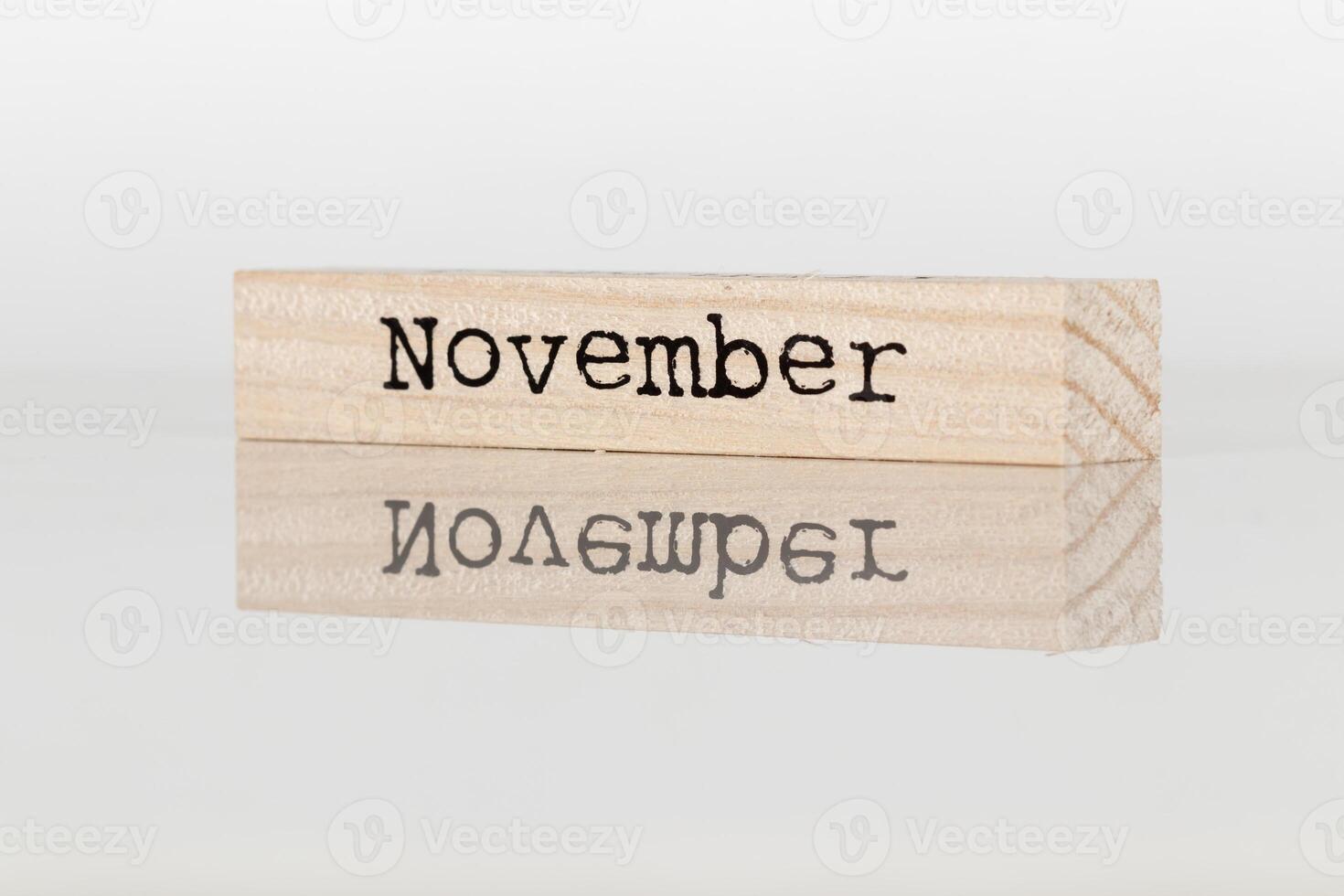 wooden cube with the inscription November on a white background photo