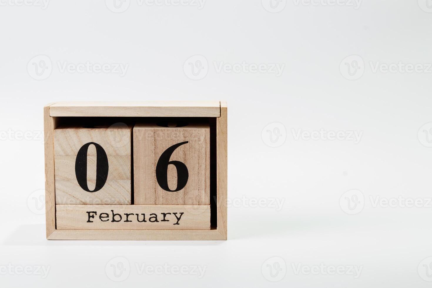 Wooden calendar February 06 on a white background photo