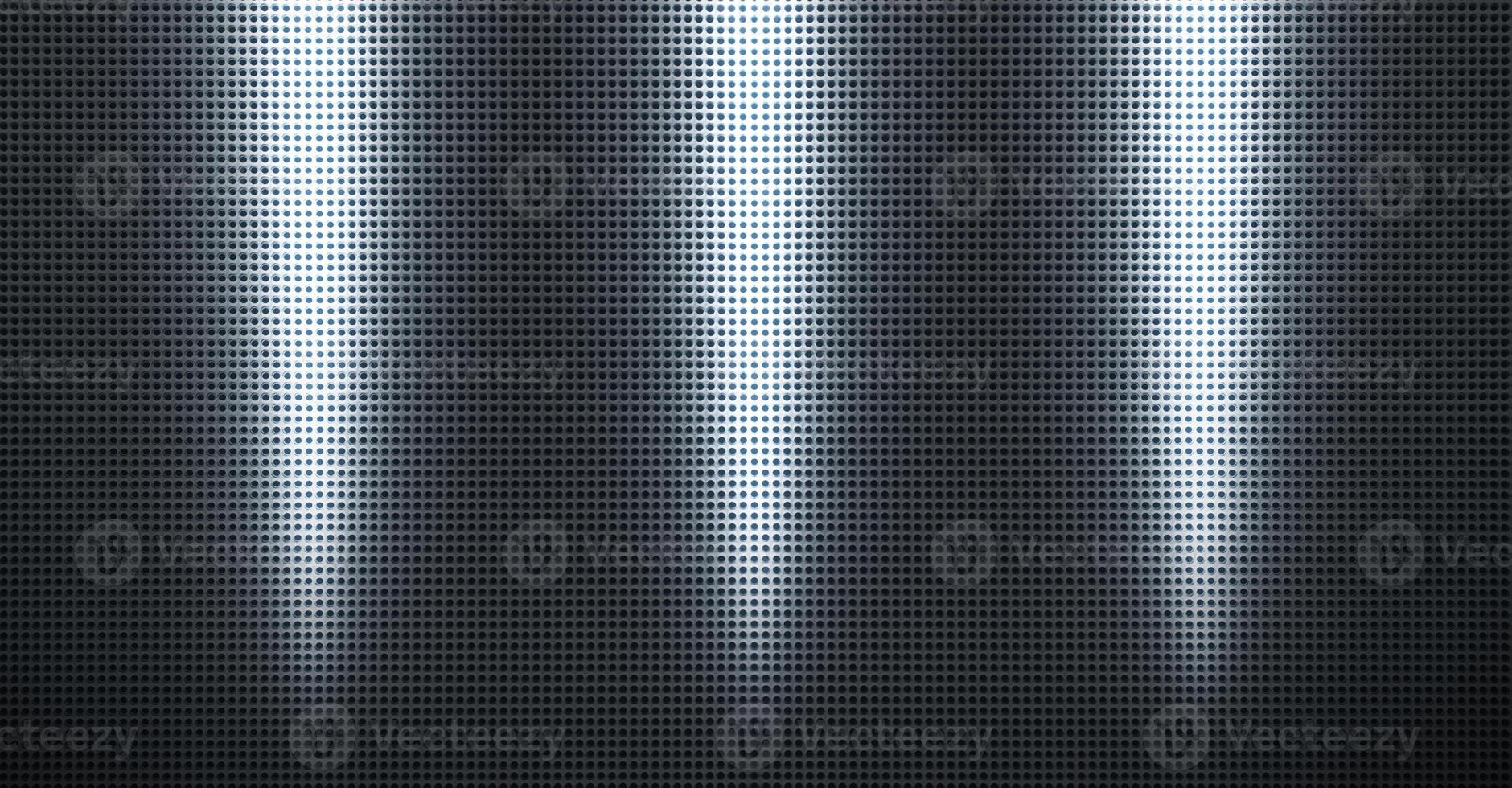 Spot lit perforated metal plate photo