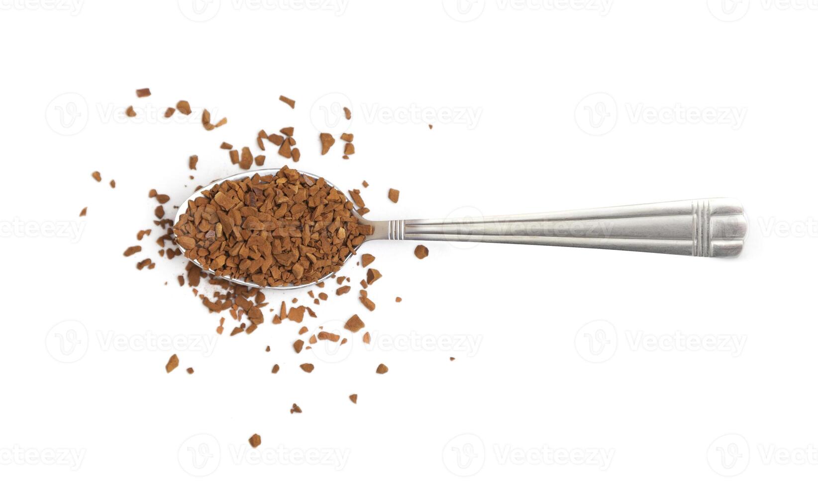 Spoon with instant coffee granules on a white background photo