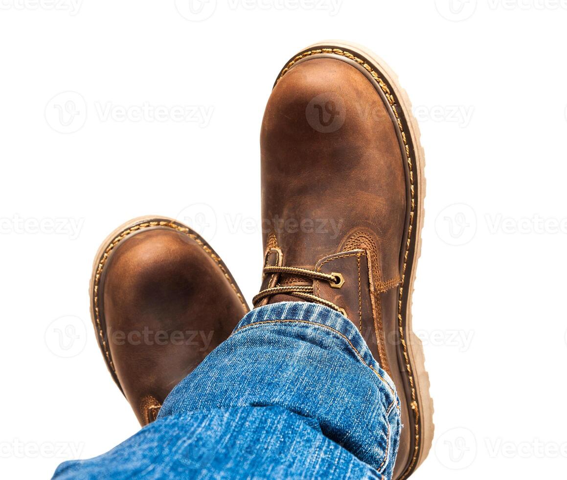 Men's brown boots and blue jeans isolated photo