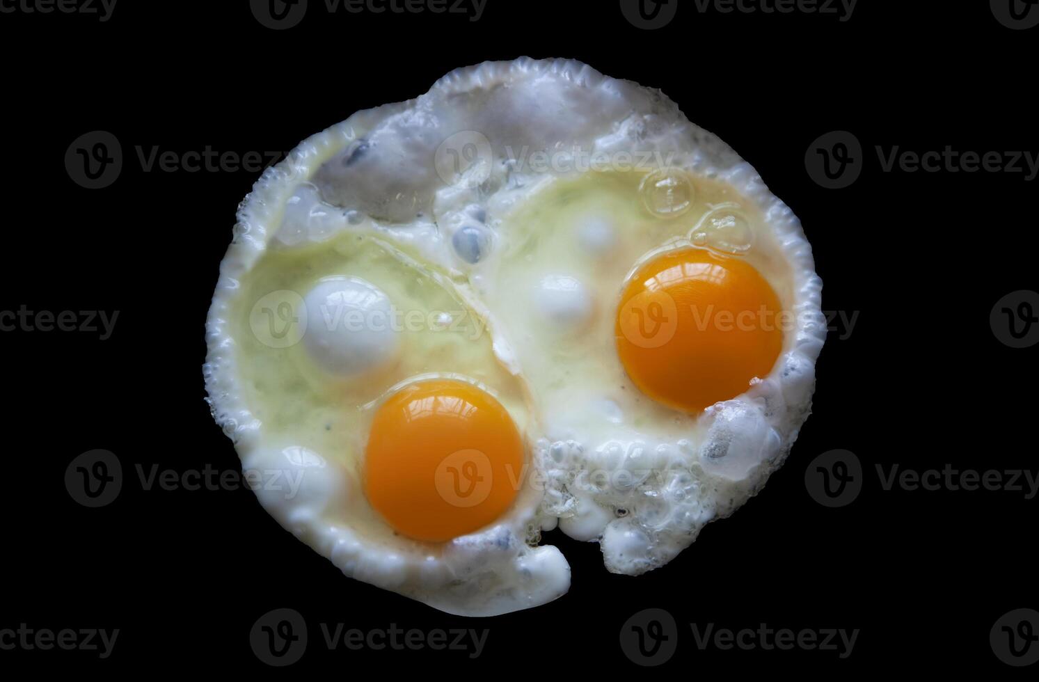 Two fried eggs Isolated on a black background view from above photo