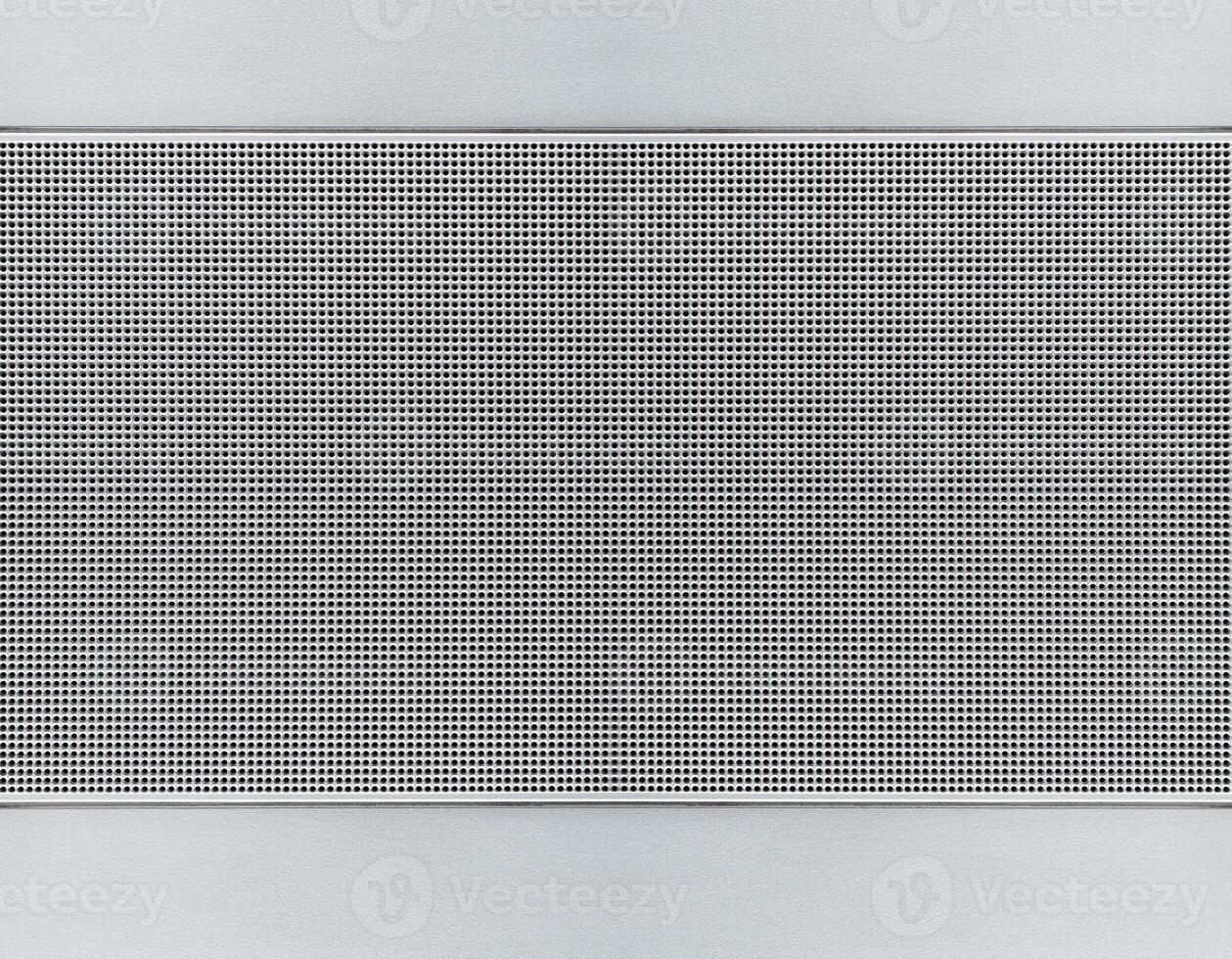 Spot lit perforated metal plate photo