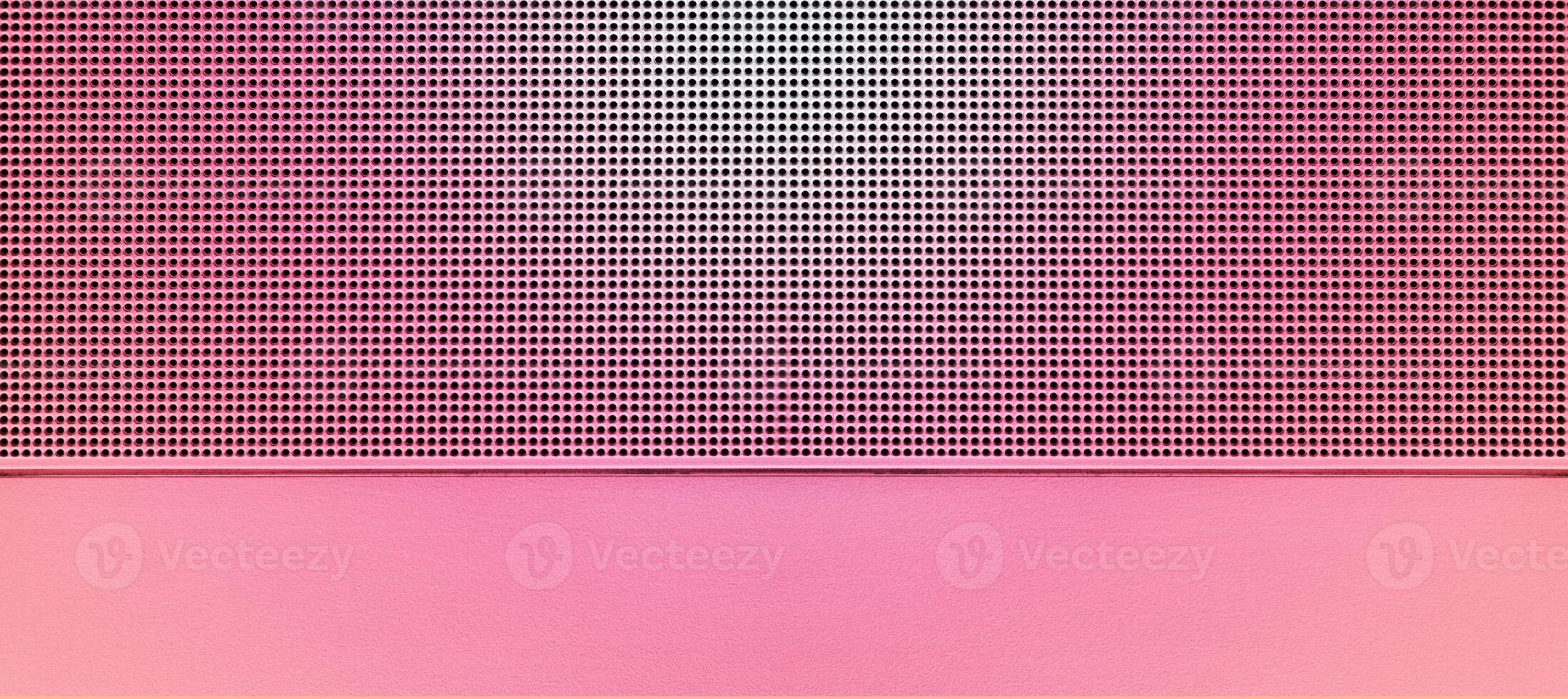 Spot lit perforated pink metal plate photo