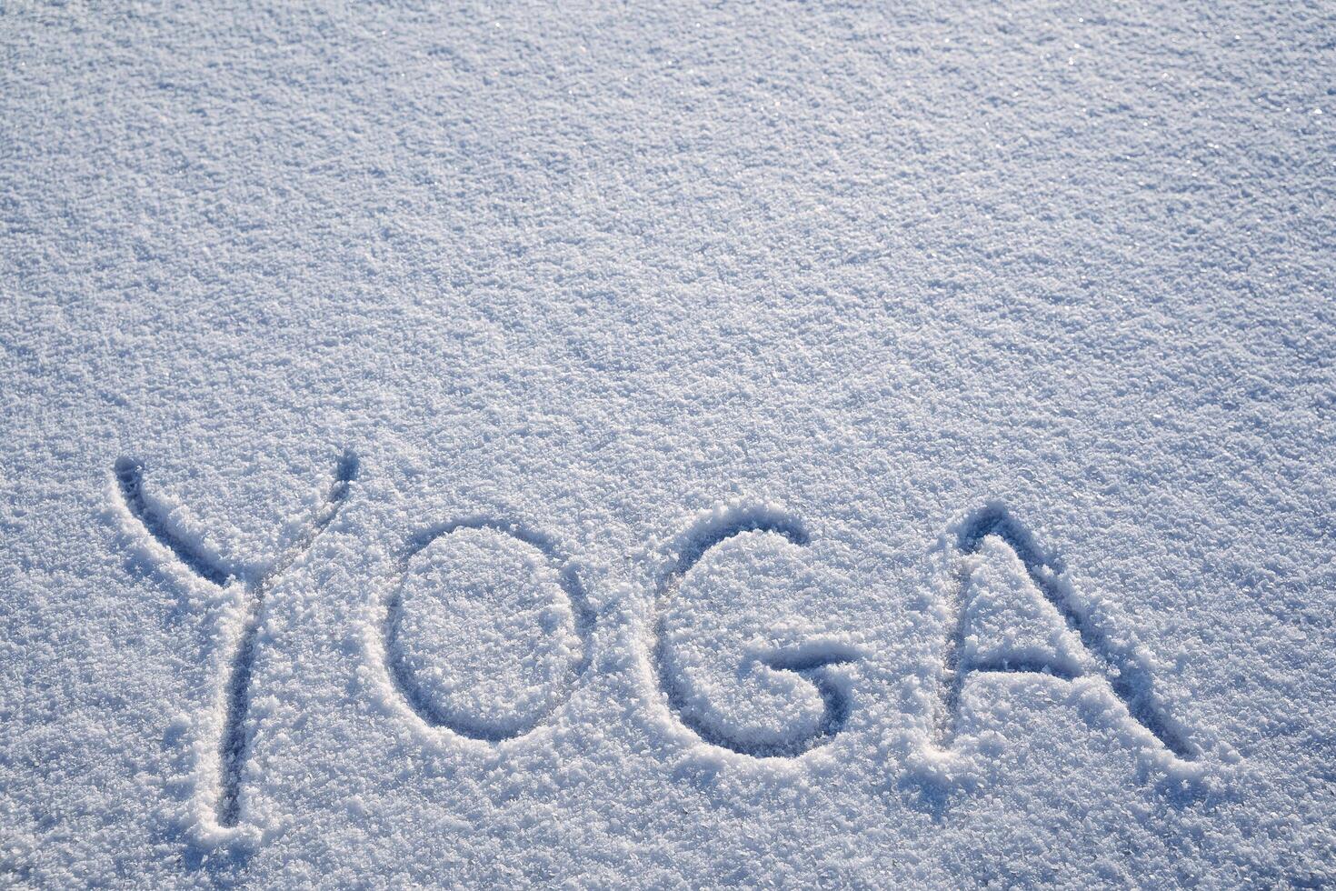 Yoga in nature. An inscription on the snow. The word yoga is written in the snow. a minimalist picture of Zen Buddhism. Peace and calmness photo