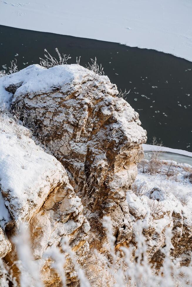 rock stone snow. View from the top to the cliffs. Russia's nature. first snow, river white snow, morning, height. beauty, wildlife photo