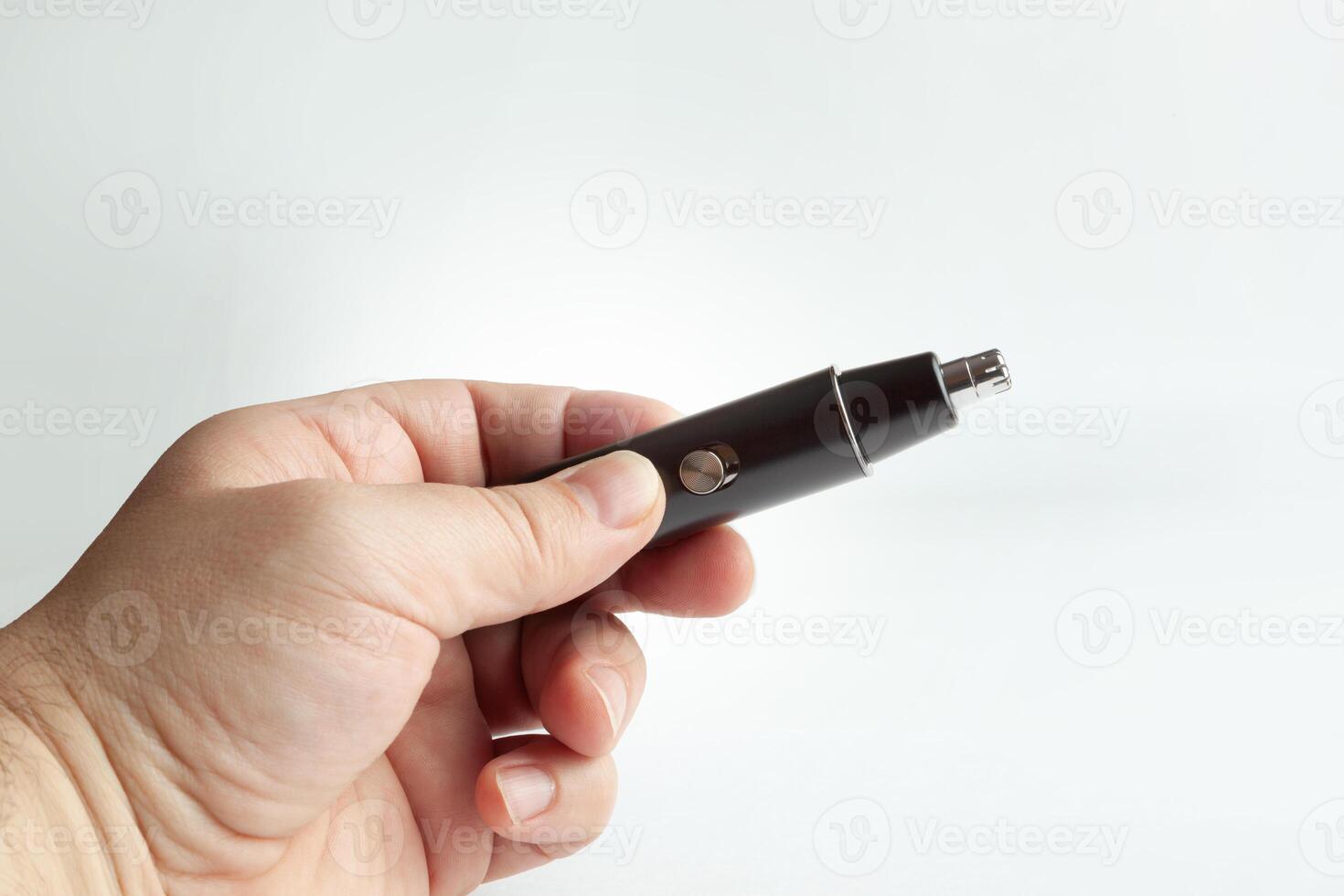 Hand holding a black nose trimmer photo