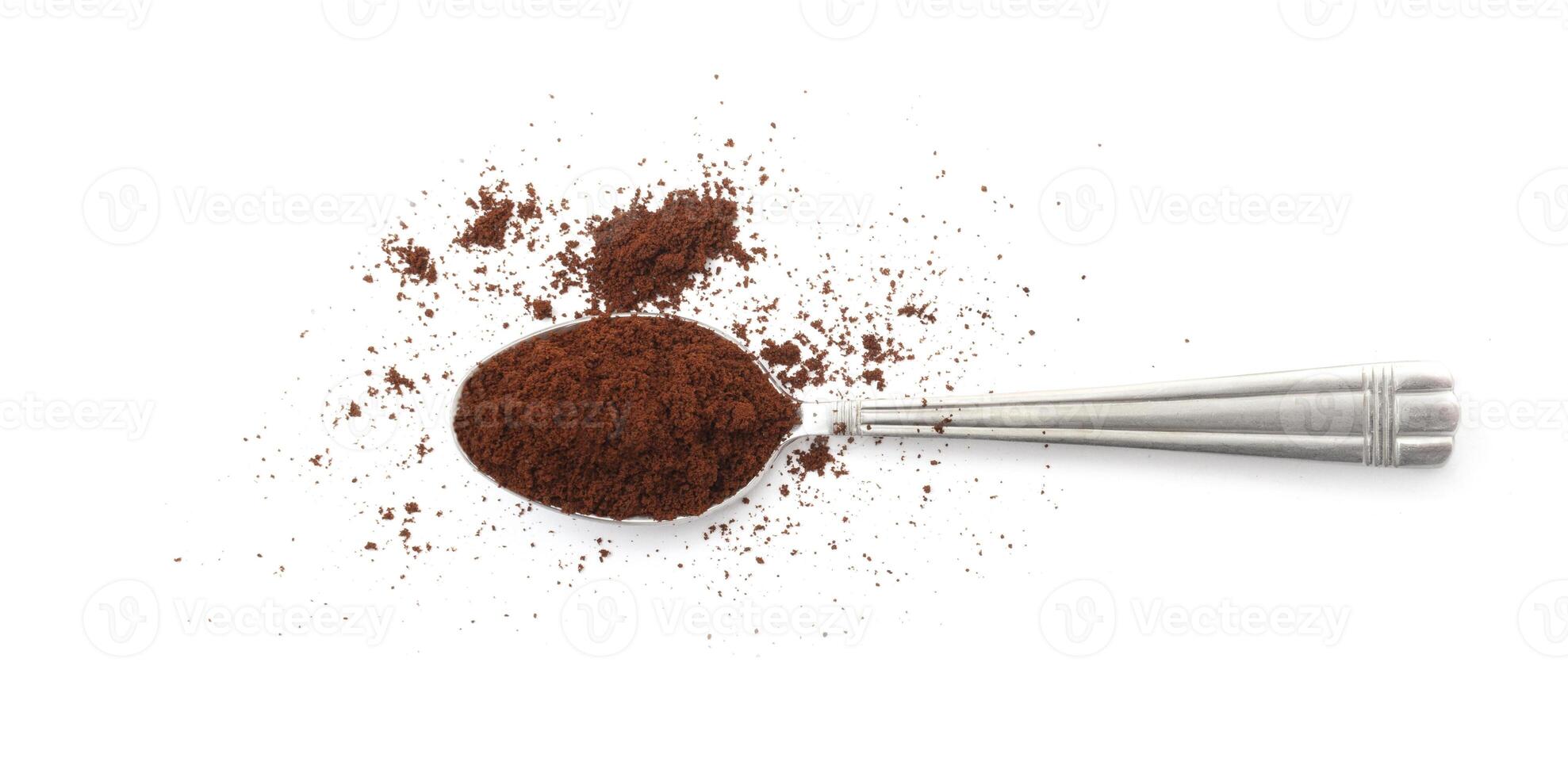 Coffee powder on spoon isolated on white photo