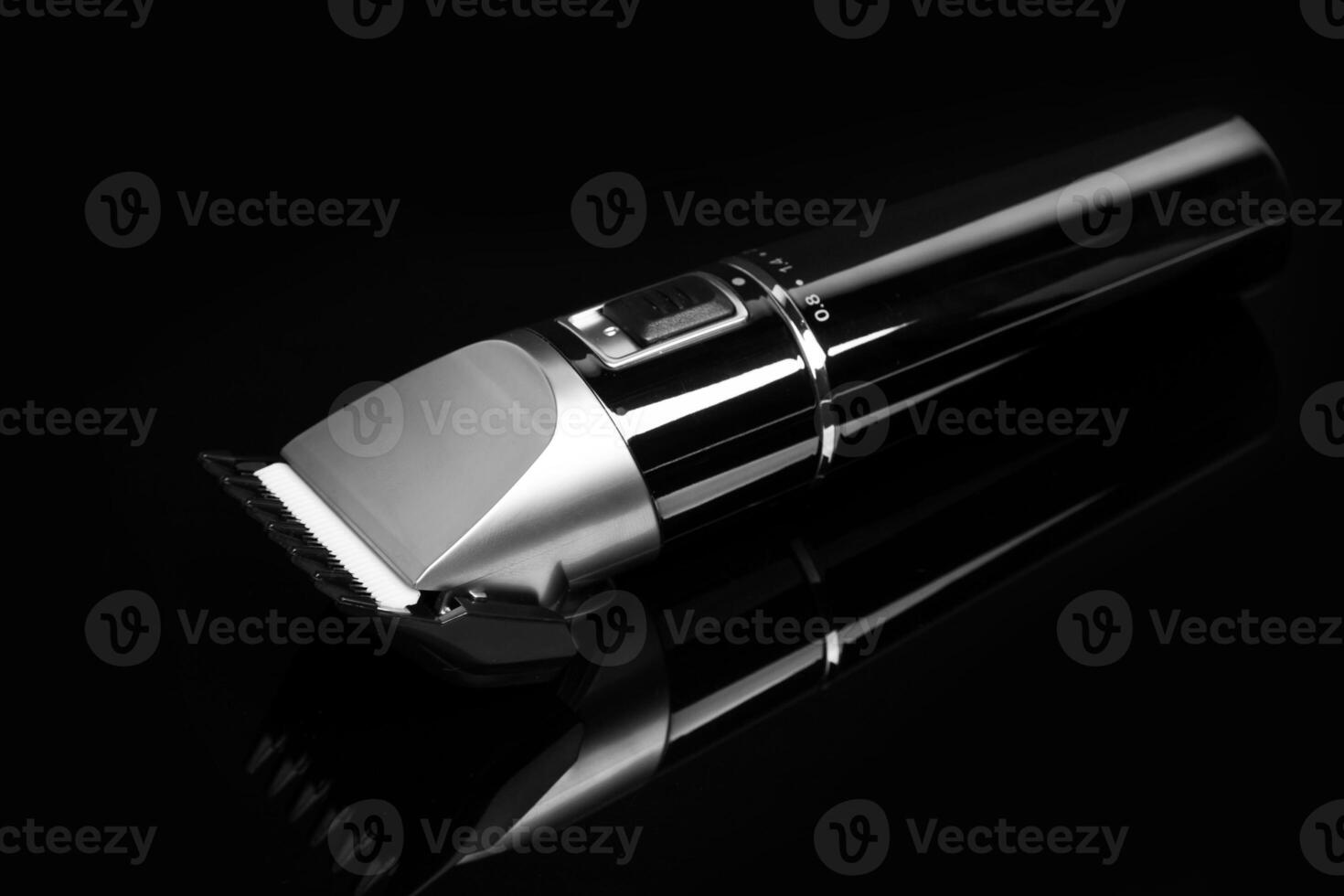 Hair clipper trimmer isolated on black background photo