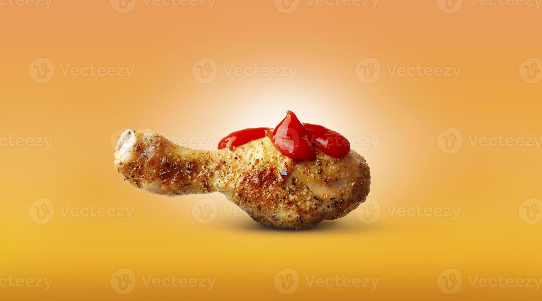 Baked chicken leg ketchup sauce spices isolated on orange background photo