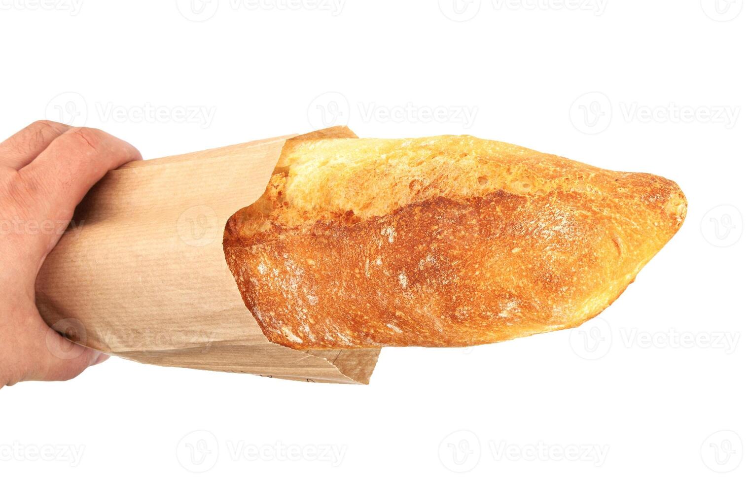 Freshly baked baguette in a paper package photo