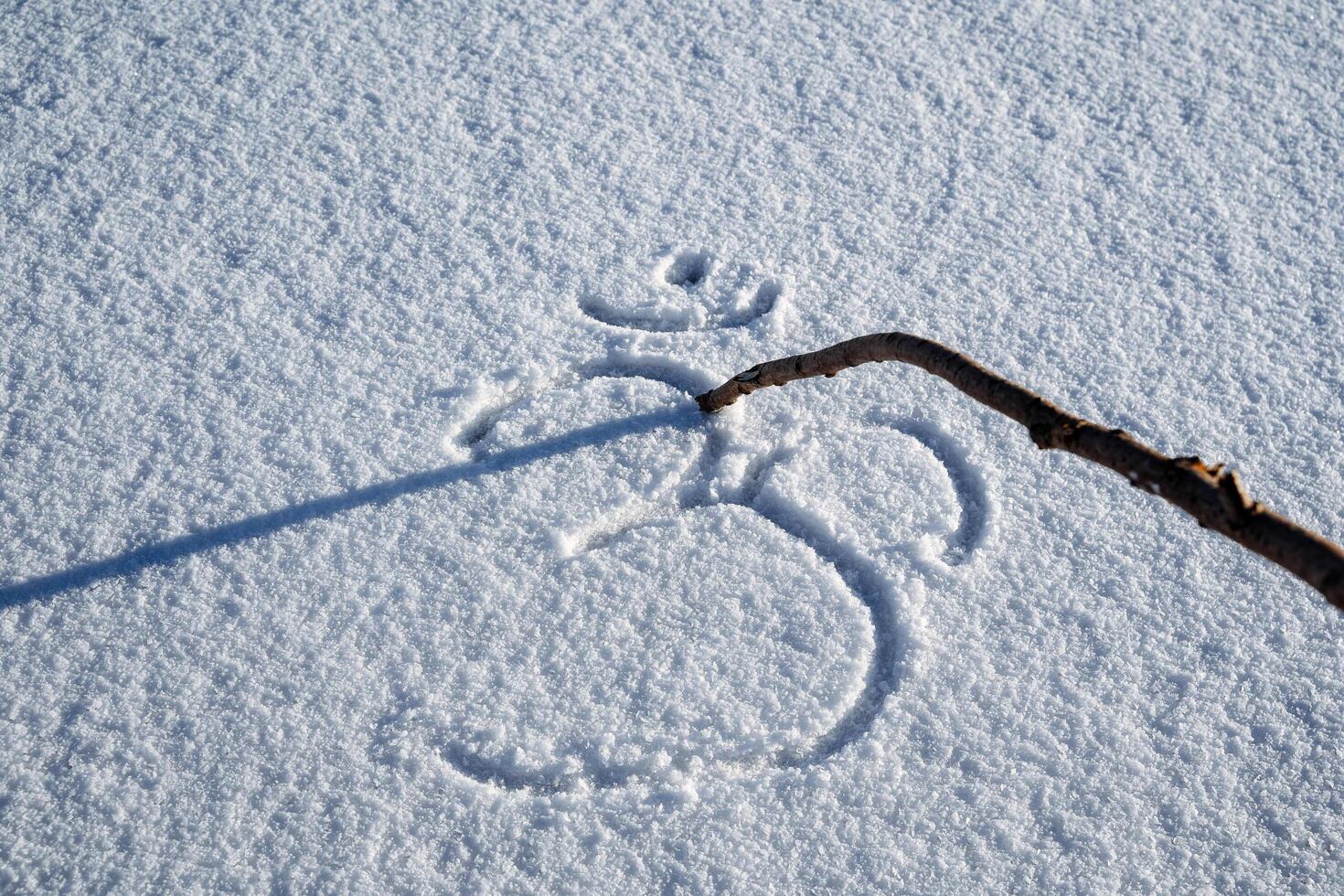 Write with a stick in the snow. The sign is written in the snow. Om shanti. The symbol of yoga represents ancient knowledge, tranquility and tranquility. Hindu sign. photo