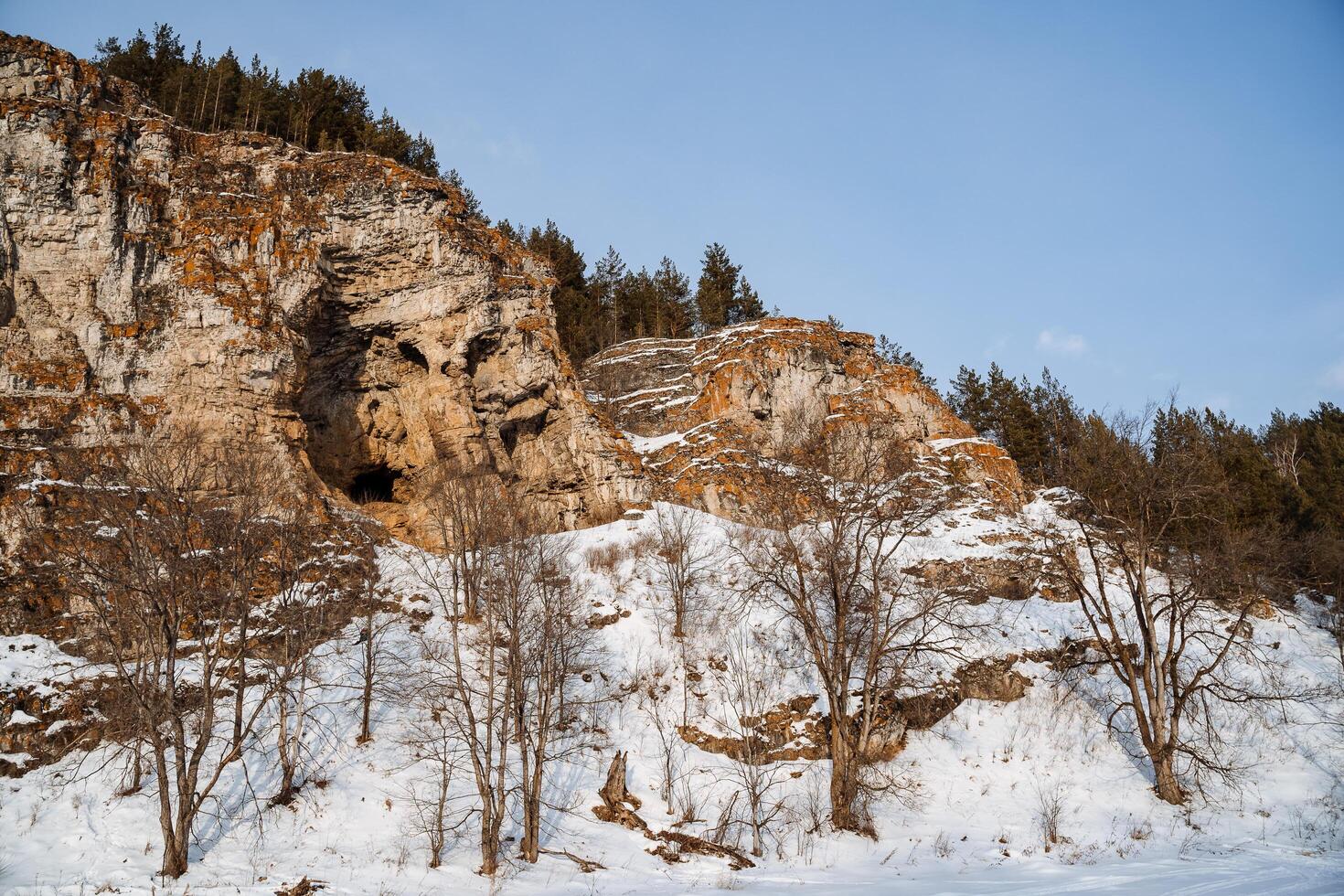 Winter view of the snow-covered nature in the mountains. Ural Mountains, Russia. Rock wall on a frozen river. Southern Urals, Chelyabinsk region photo