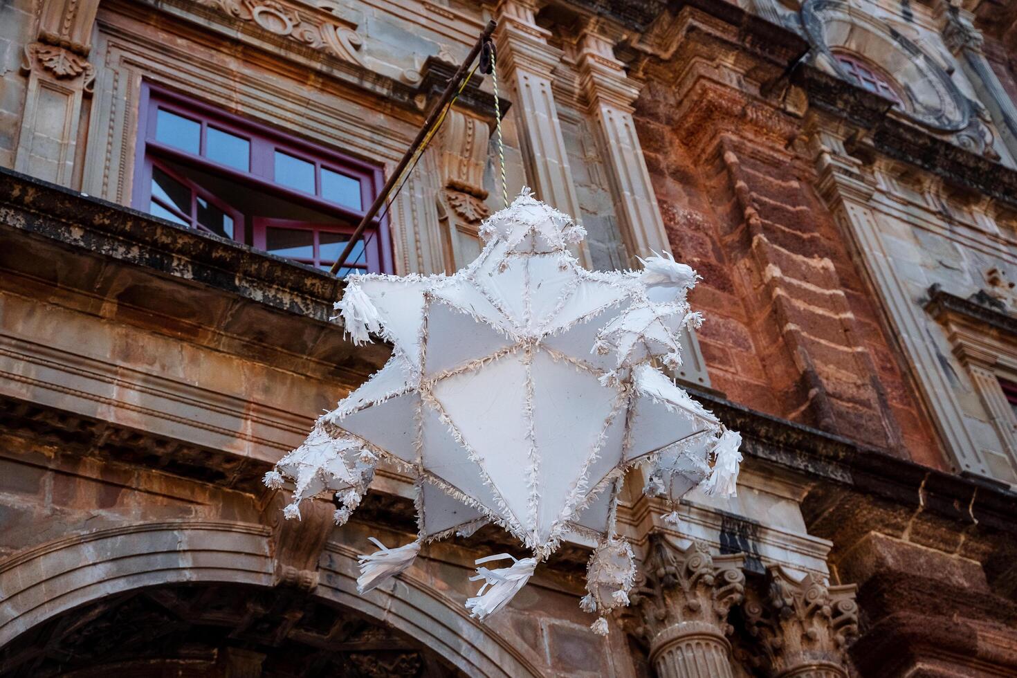 Paper lantern decoration. A white Chinese lantern hangs on the old building. Carnival decoration. photo