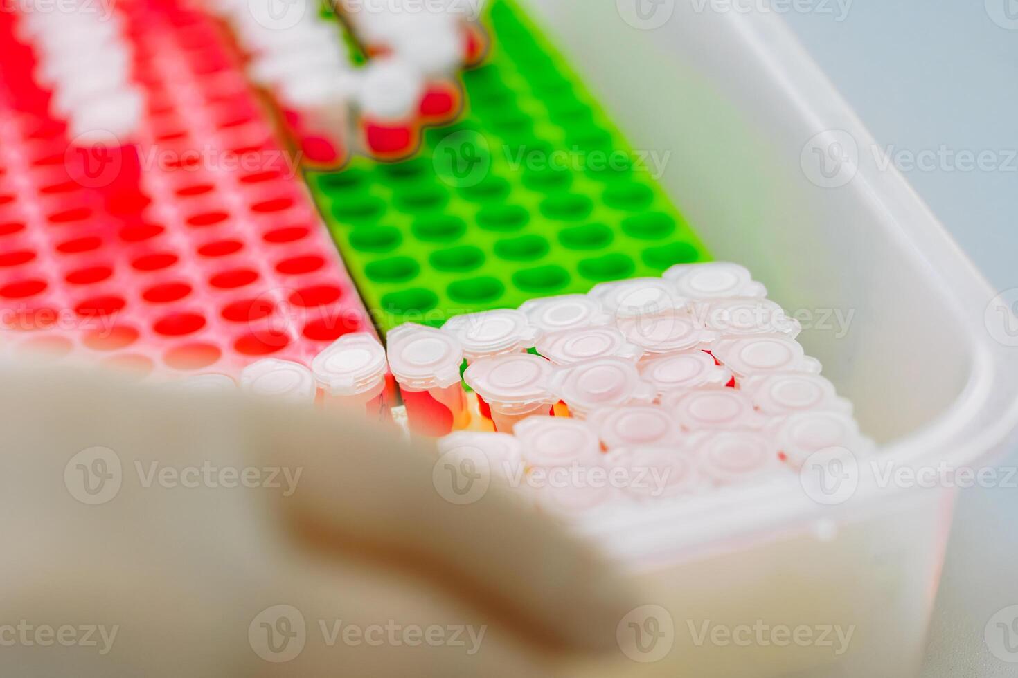 Professional laboratory workers pouring blood samples into vials on the table. photo