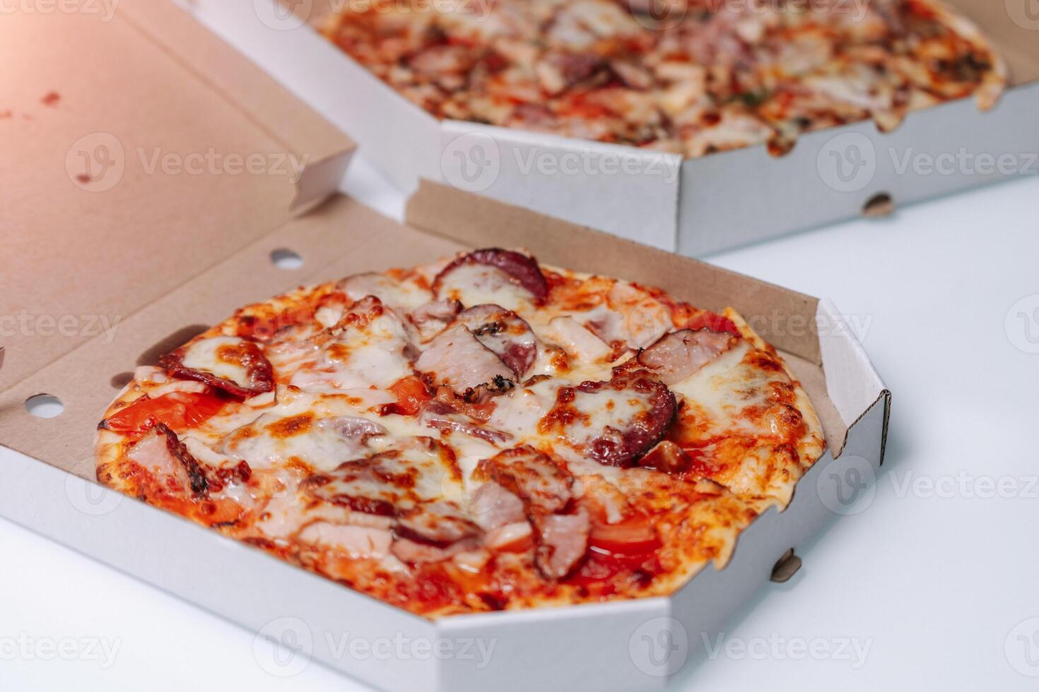 Delivery box with delicious pizza on white background. photo