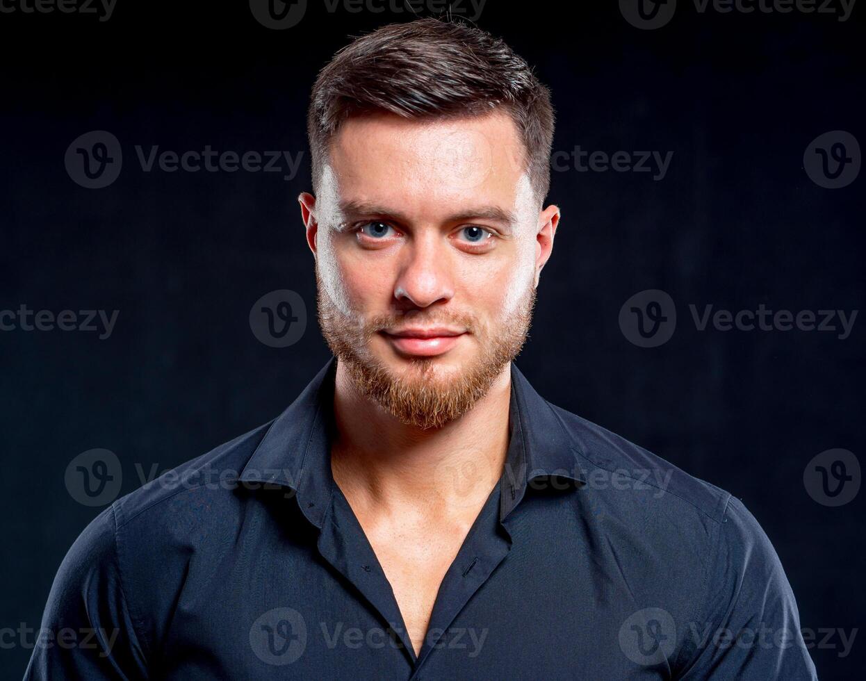 Portrait of smiling muscular man. Sexual muscular man posing over background photo