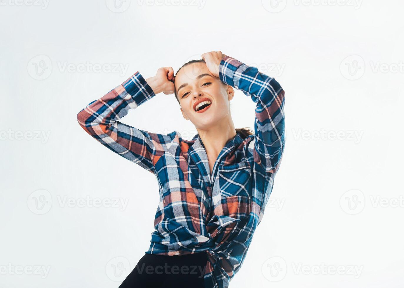 Portraite of attractive smiling girl in stylish clothers. Beautiful happy model in the studio against white background photo