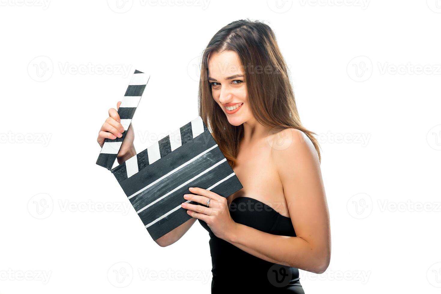 Girl with clapper board. People's emotions. Isolated background. Close up. Beauty with awesome smile. Brunette opens calpperboard. Isolated background. Closeup. photo