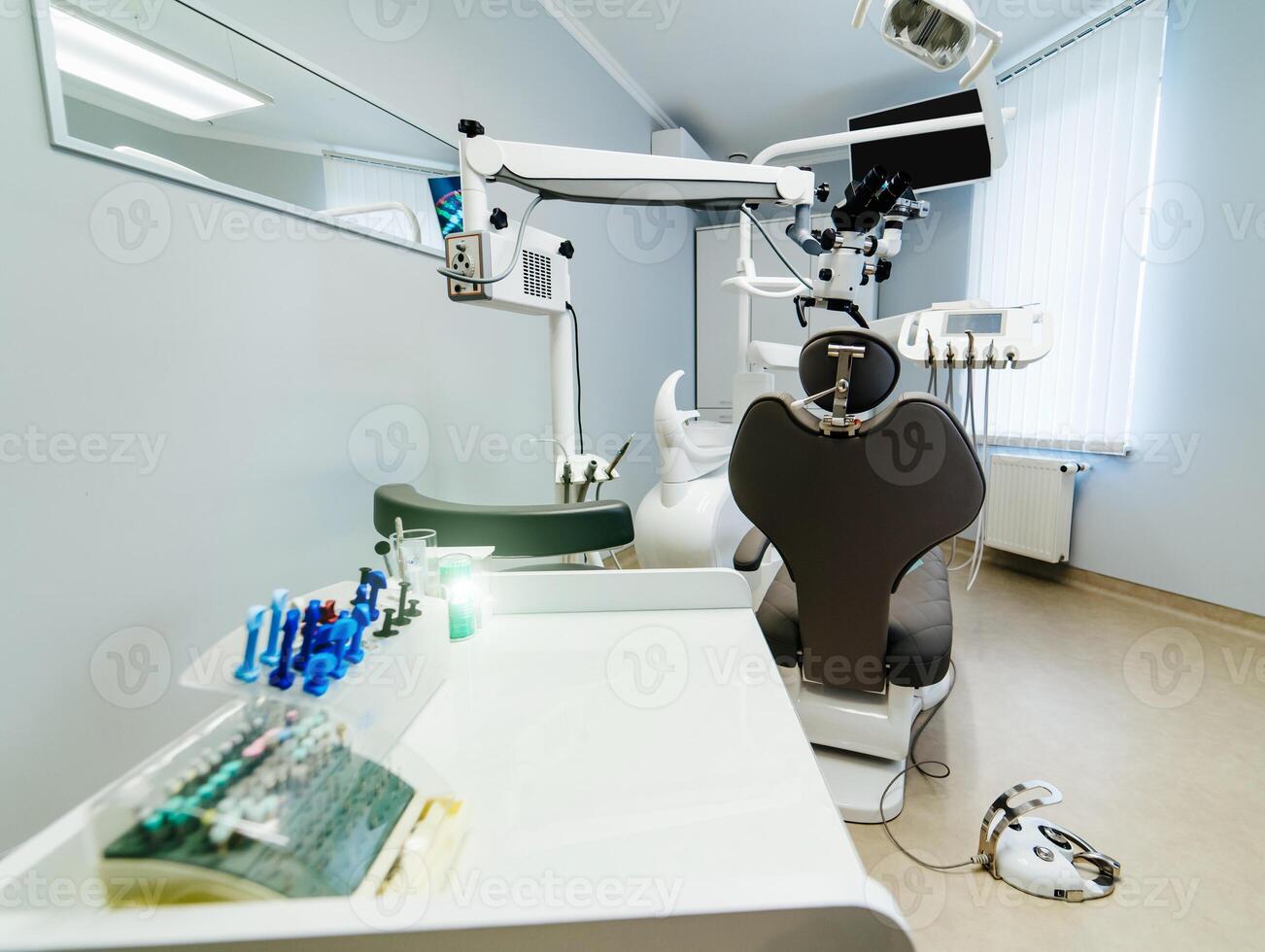 Brand new medical office. Advanced Dentist room with microscope. Stomatologist' professional equipment. Hi tech medical clinic. Dentist clinic. Modern dental office interior. photo