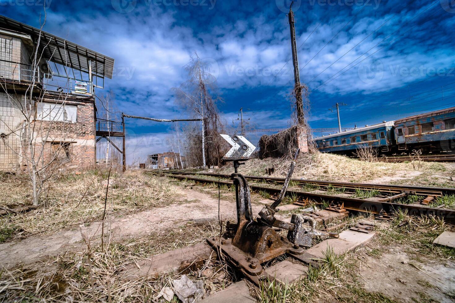 Abandoned railway station . Rusty weathered peeled paint of an old wagon. Blue railway carriage. photo