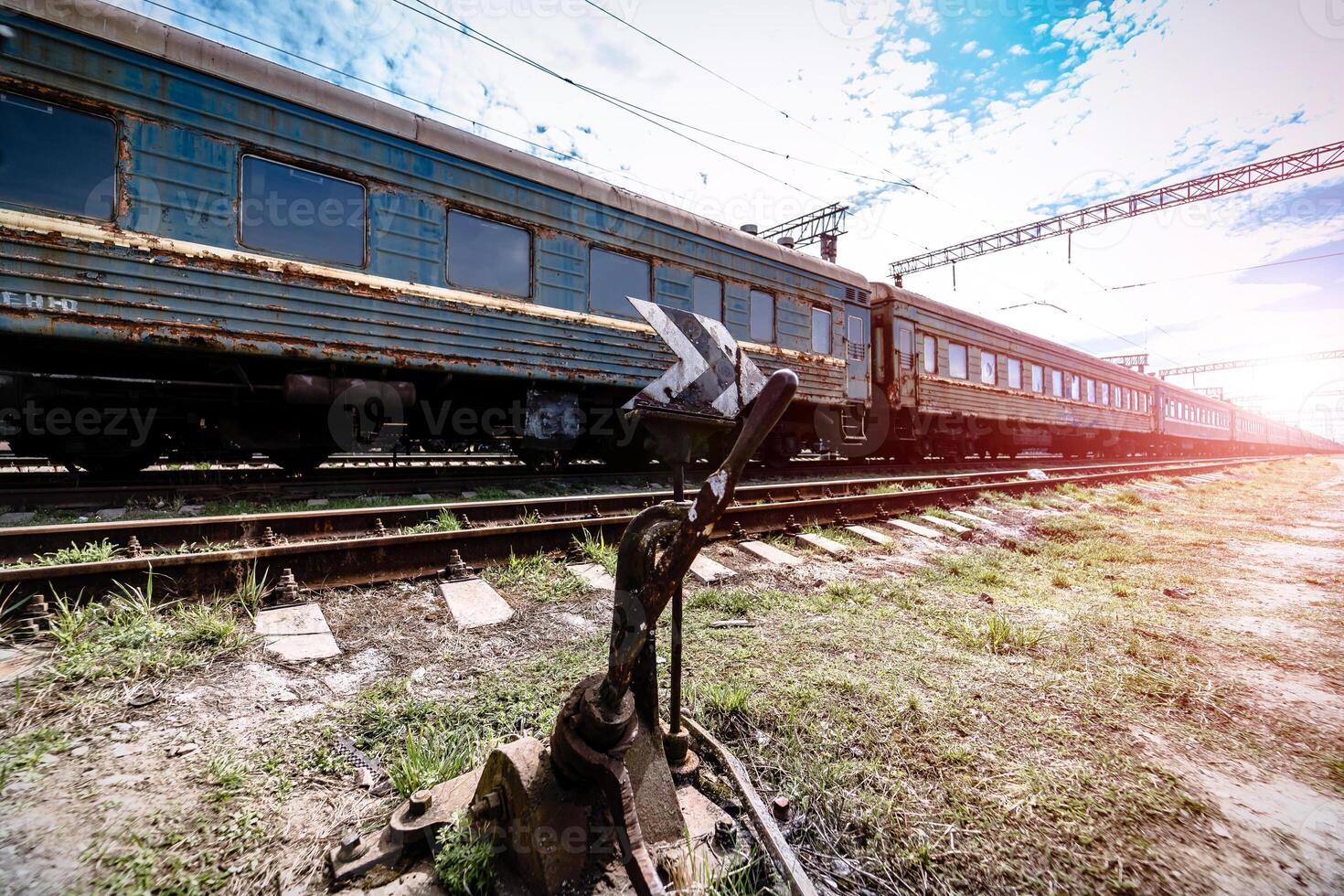 old rusty weathered peeled paint of an old wagon. Blue abandoned railway carriage. Old railwaystation. photo