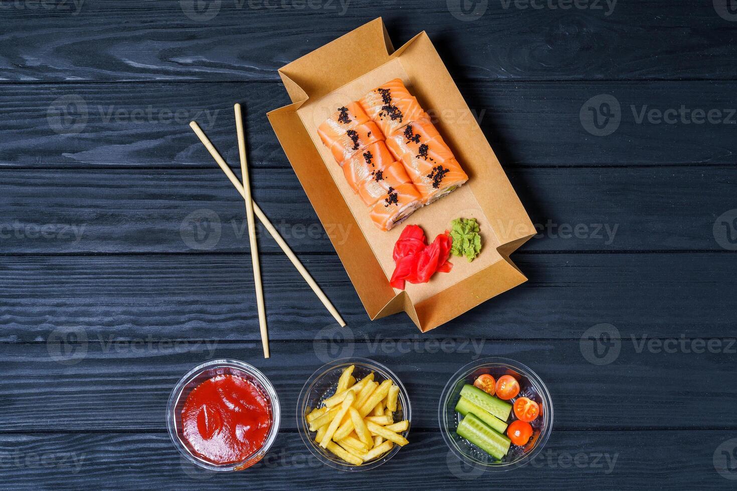 Food delivery, sushi rolls. Set of sushi in a cardboard box. Fast food photo