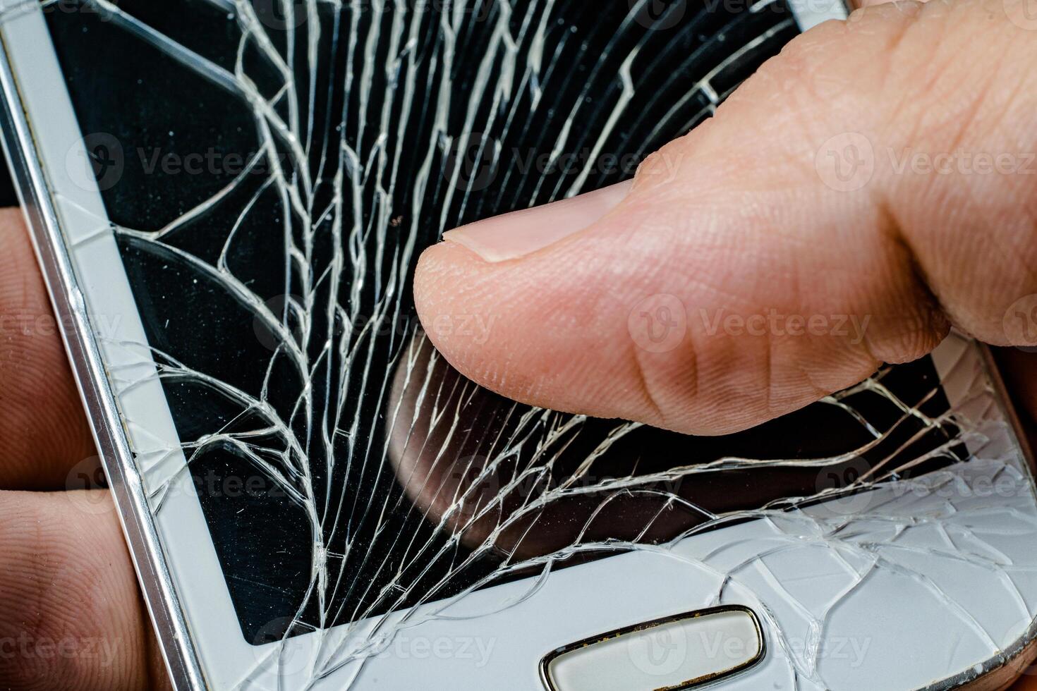 Smartphone with cracked display in hand photo