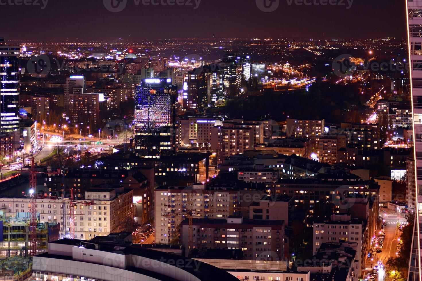 View of at night glass buildings and modern business skyscrapers. View of modern skyscrapers and  business buildings in downtown. Big city at night. photo