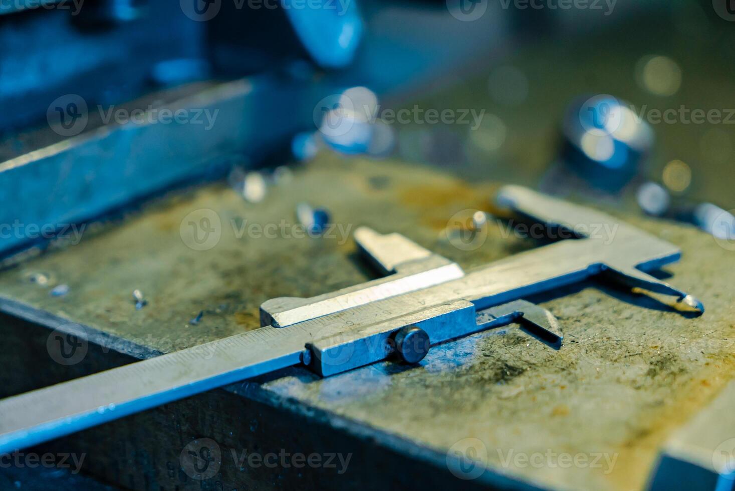 metal detail is on the table near the lathe in the factory. Close-up photo