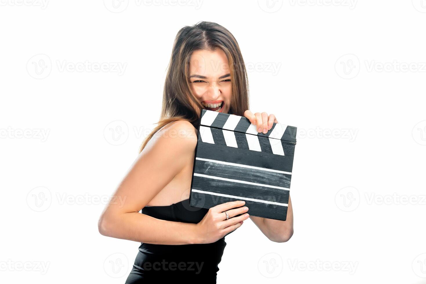 Girl with clapper board. People's emotions. Isolated background. Close up. Beauty is winking to the camera. Closeup. photo