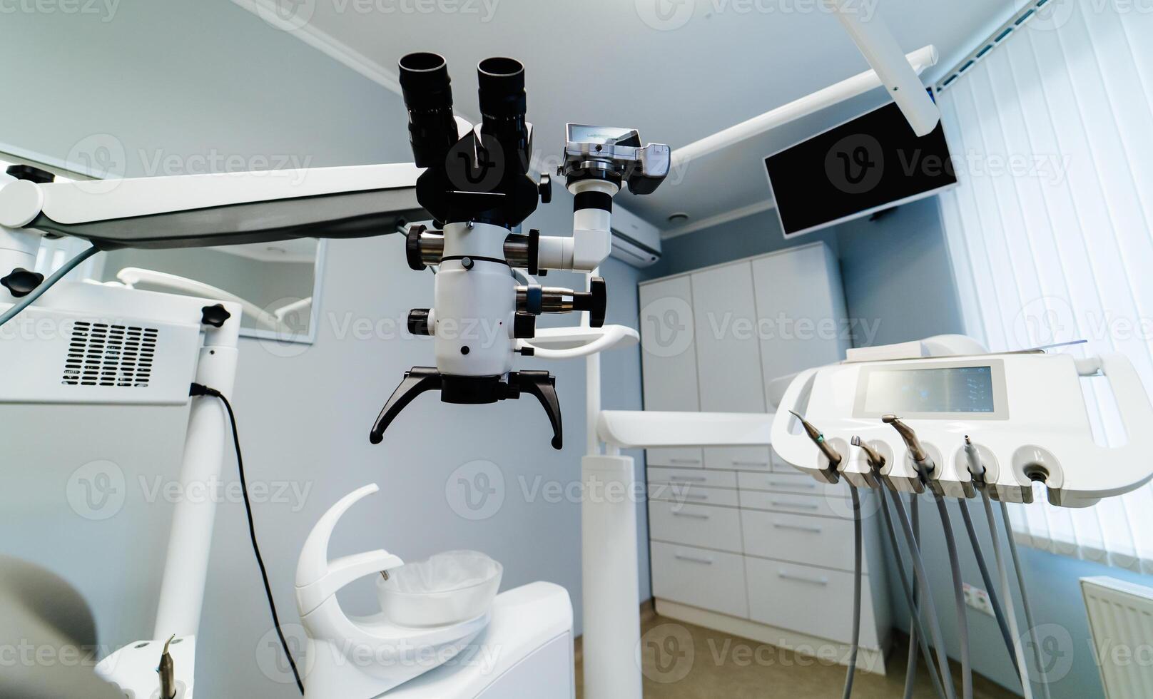 Brand new medical office. Dentist room. Stomatologist professional equipment. Hi tech medical clinic. Dentist clinic. Modern dental office interior. Advanced Microscope for teeth treatment. photo